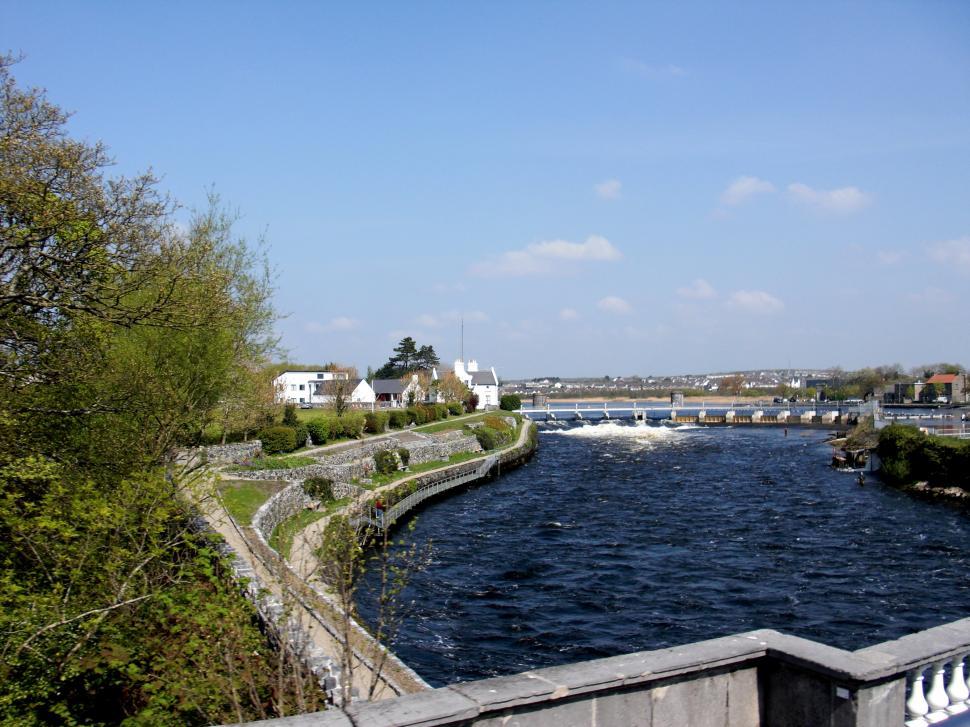 Free Image of River Running Through City Next to Bridge 
