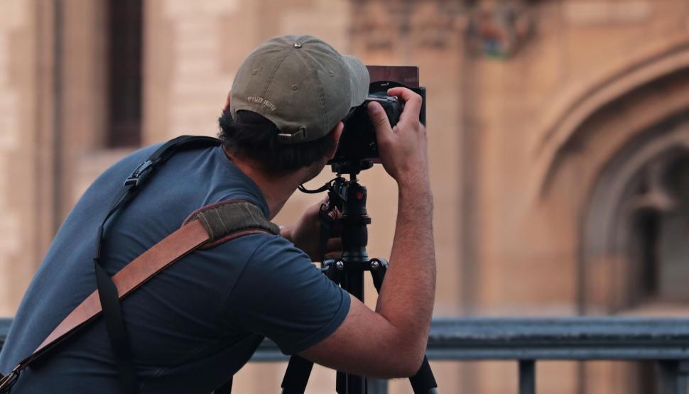 Free Image of Back Side view of photographer with camera 
