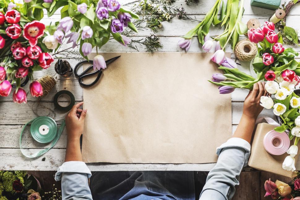 Free Image of Flat lay of a florist table - blank brown paper 