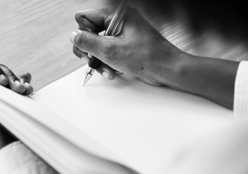 Free Image of Close up of hand writing on a notebook 