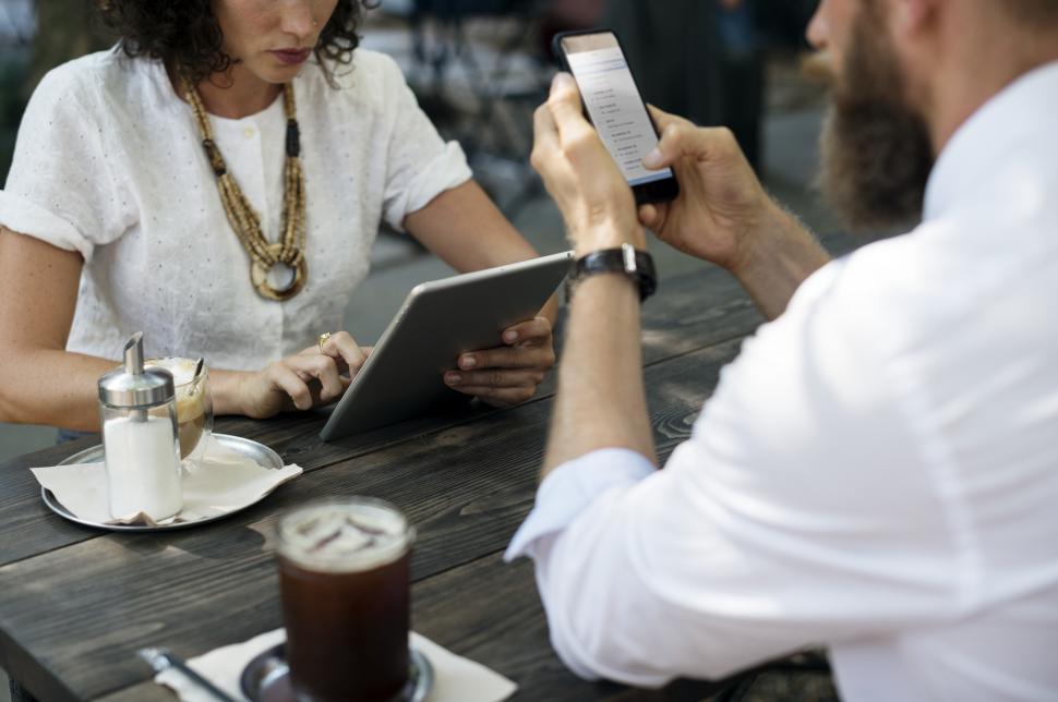 Free Image of Close up of two people meeting at an outdoor restaurant table 