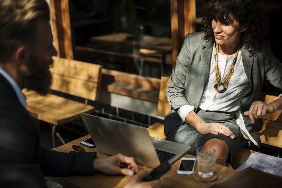 Free Image of People in discussion at an outdoor table 