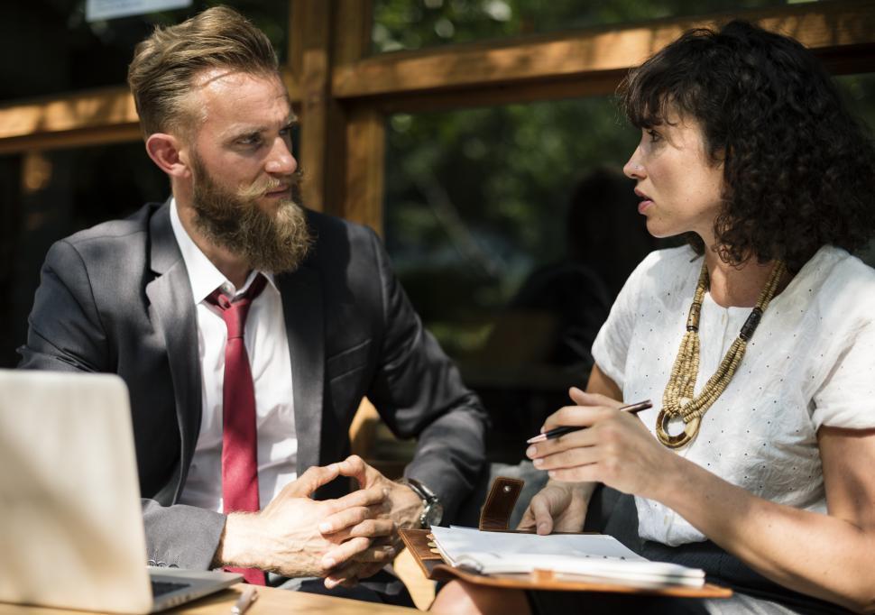 Free Image of Close up of two people meeting at an outdoor restaurant table 