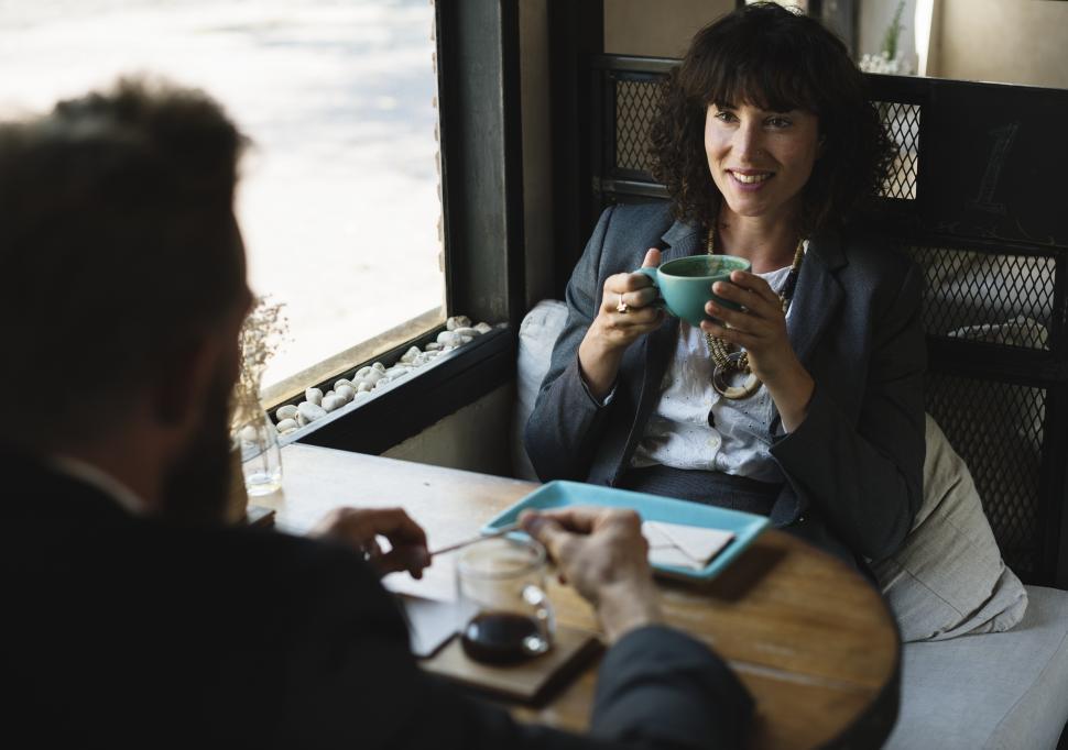Free Image of Two business people discussing business maybe at a restaurant table 