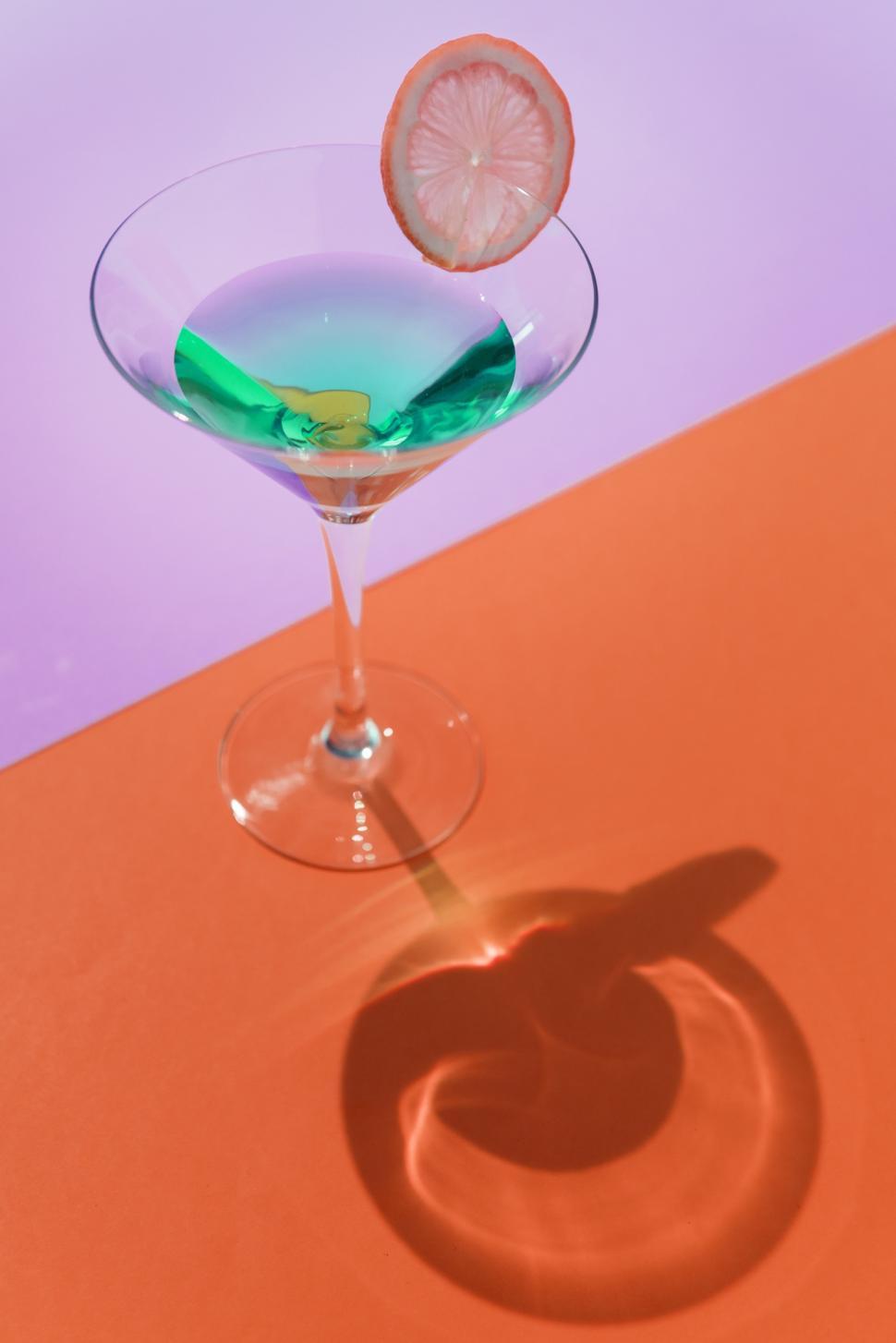Free Image of Close up of a glass of martini on colorful background 