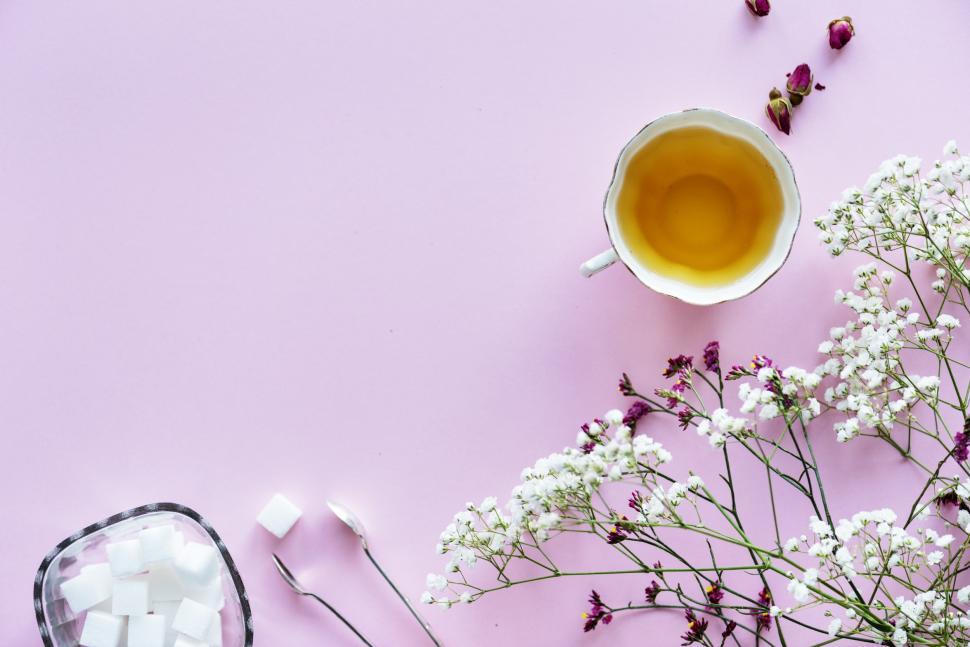 Free Image of Flat lay of a cup of herbal tea and dries roses 