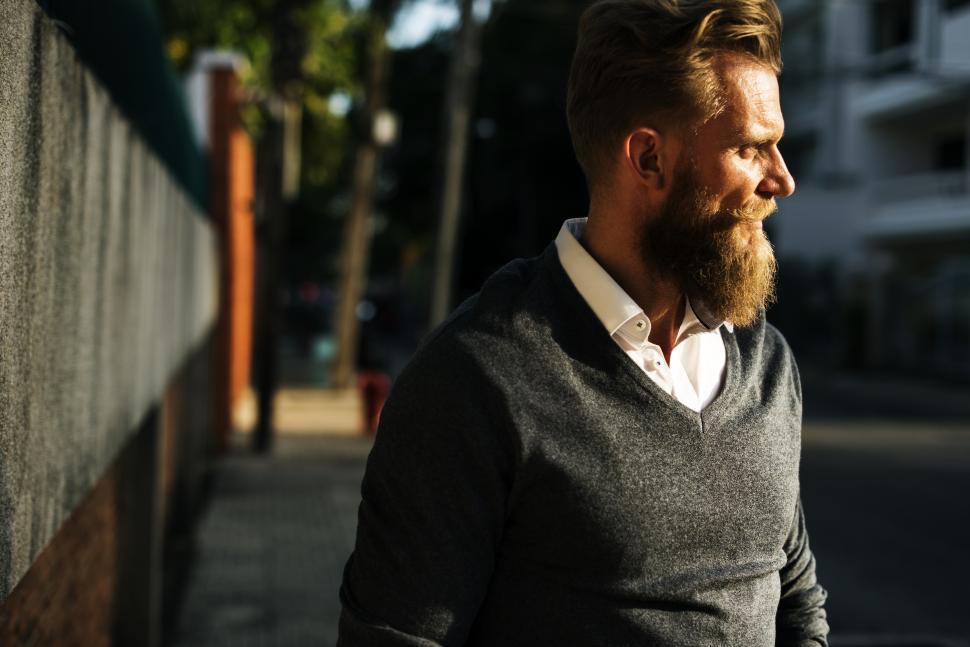 Free Image of A bearded Caucasian man wearing white shirt and sweater 
