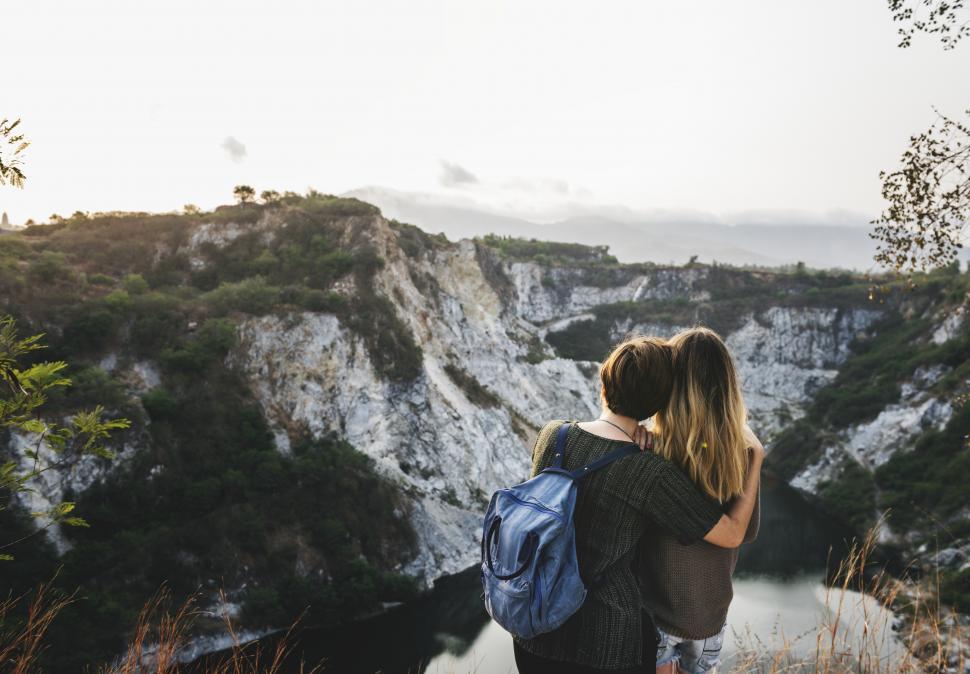Free Image of Rear view of two young female hikers looking at landscape 