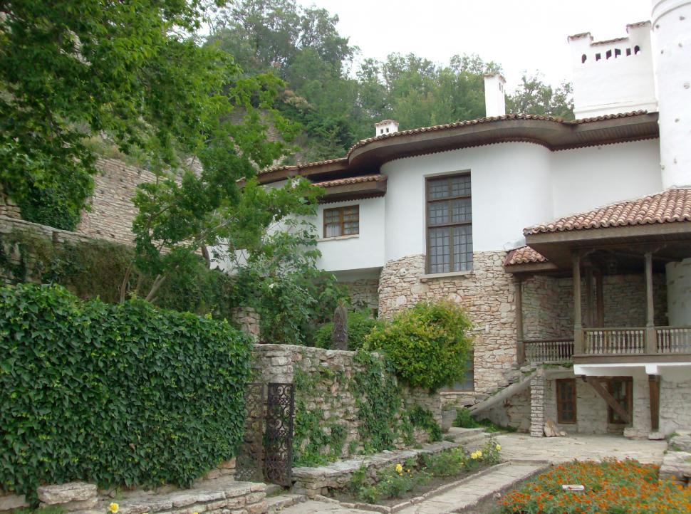 Free Image of Small garden full with flowers and stone alleys 