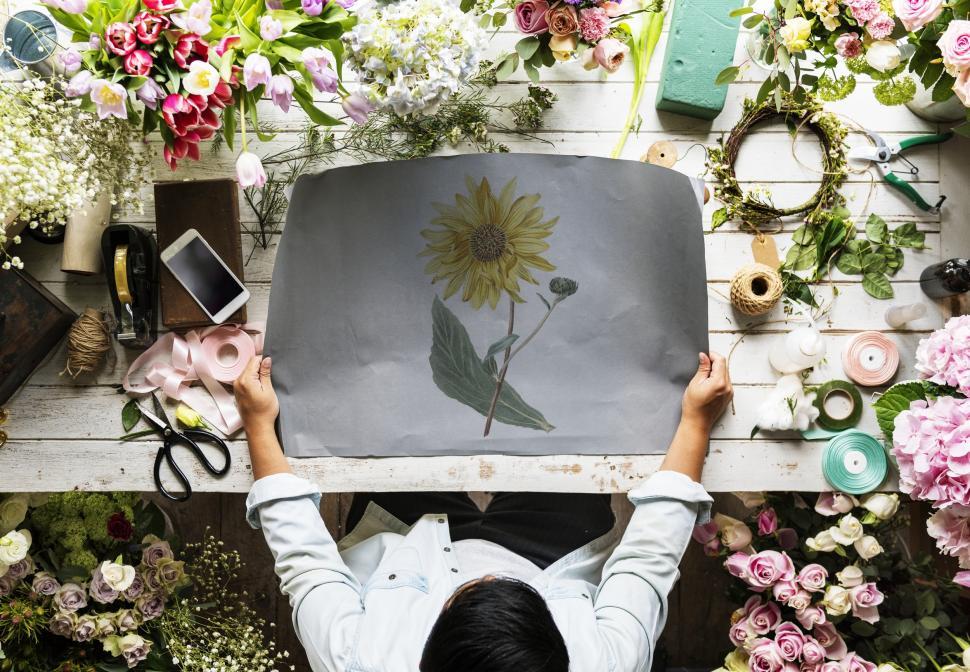 Free Image of Paper with flower illustration on a florist s table 