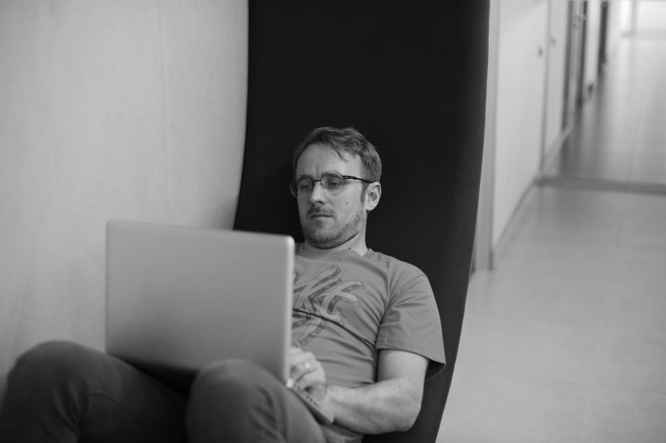 Free Image of A young man working on his laptop - black and white image 
