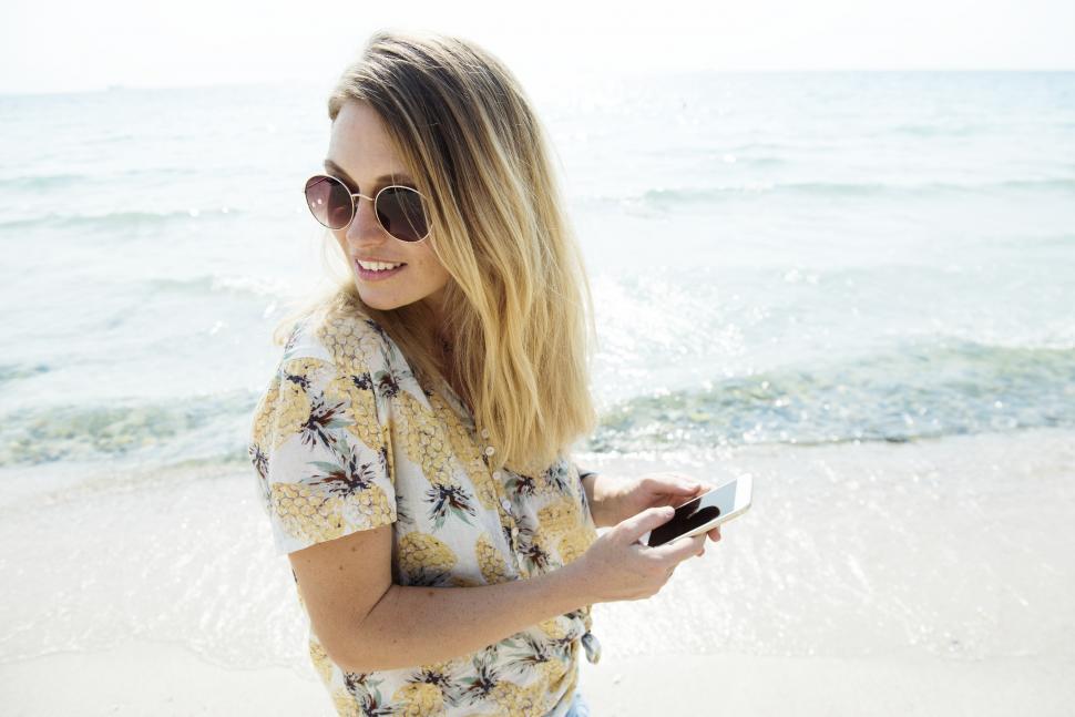 Free Image of A young Caucasian woman on the beach near small waves 