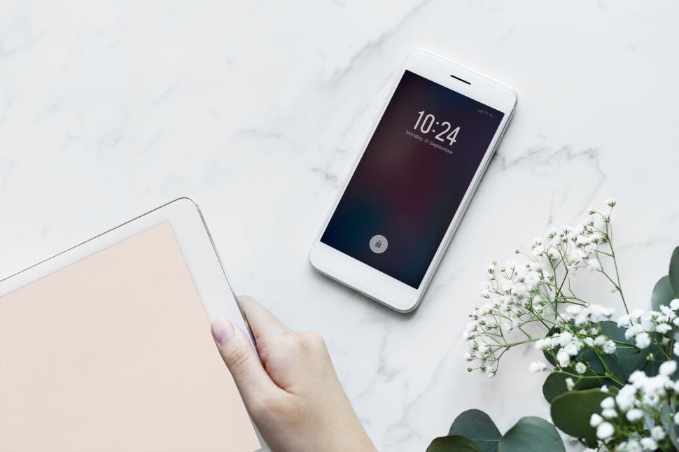 Free Image of Overhead view of a mobile phone on marble surface 