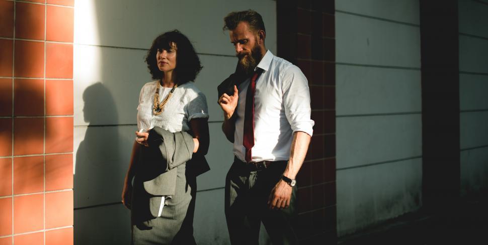 Free Image of Two people talking and taking a walk outside 