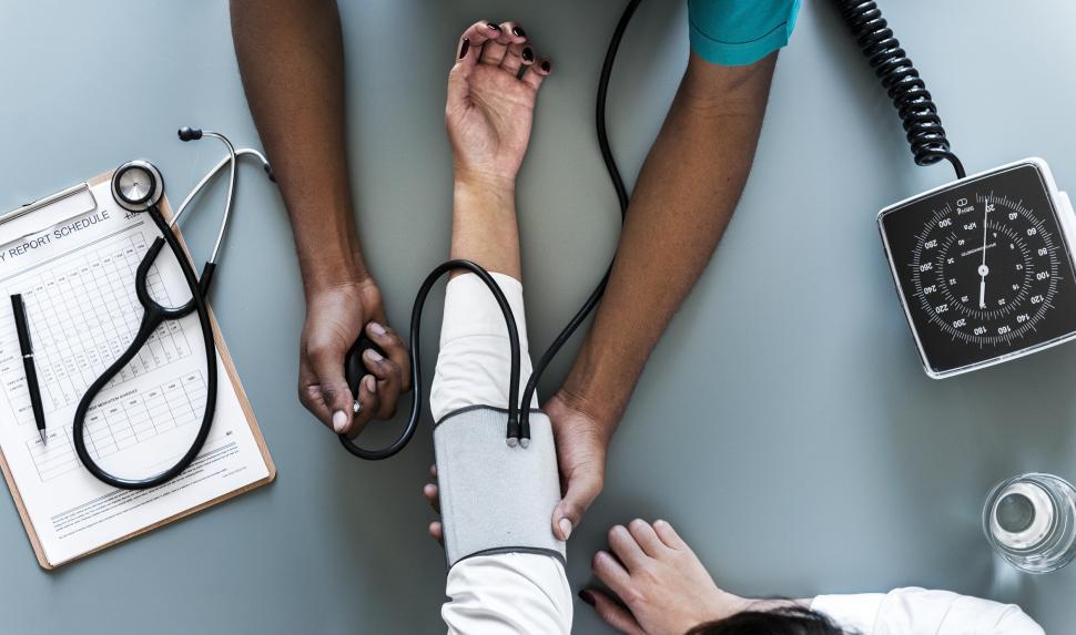 Free Image of Overhead view of a doctor monitoring blood pressure 