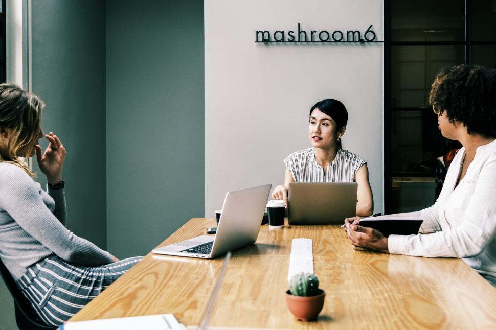Free Image of Women colleagues in a business meeting, discussions around a table 