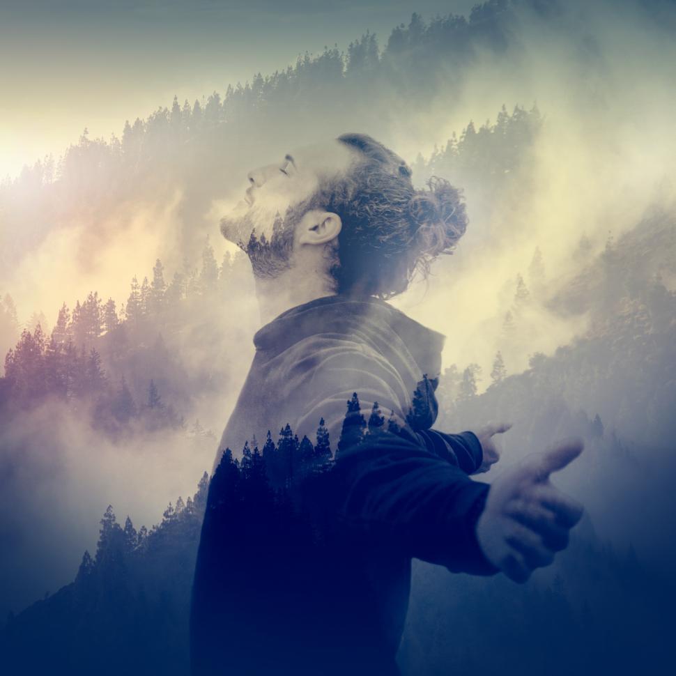 Free Image of In Communion with Nature - Man Breeding Fresh Air Over Foggy Lan 