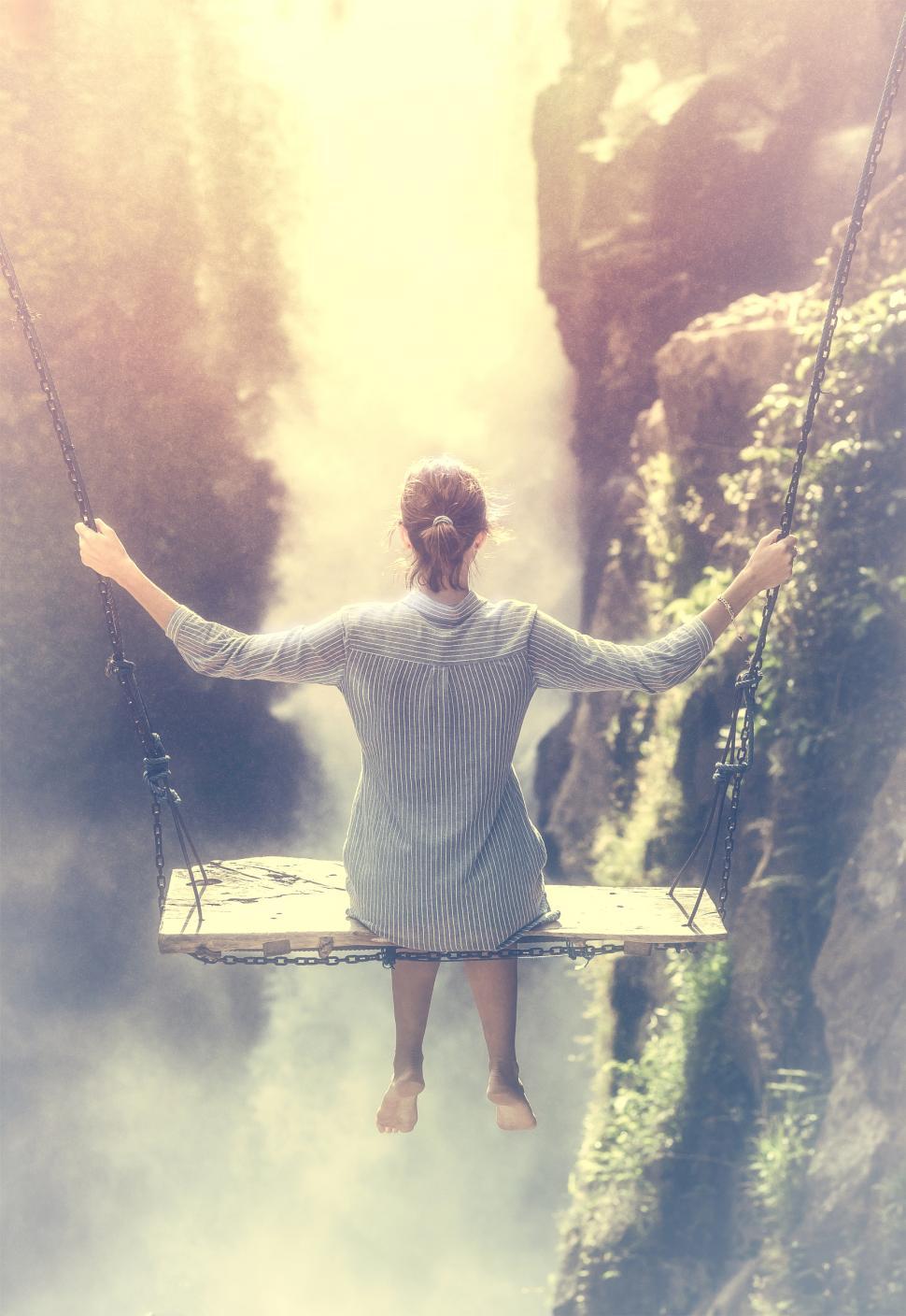 Free Image of Young Woman on a Swing in Front of Waterfall 