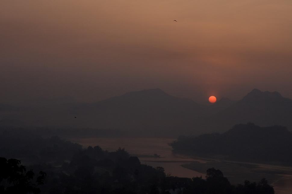 Free Image of Sun Setting Over Mountain Range 