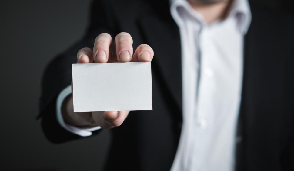 Free Image of Close up of a hand holding a business card 