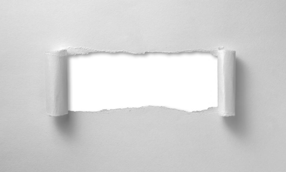Free Image of A hole ripped through paper sheet - curled edges 