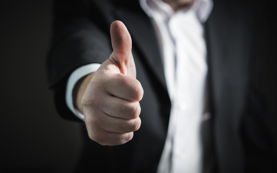 Free Image of A business person showing thumbs up sign 