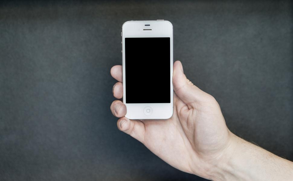 Free Image of A hand posing with a smartphone 