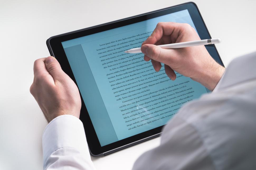 Free Image of Close up of person using a stylus tip on the tablet PC screen 