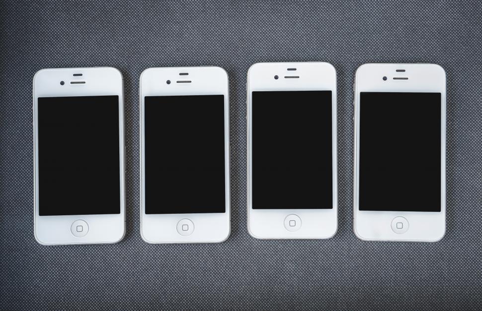 Free Image of Overhead view of four smart phones 