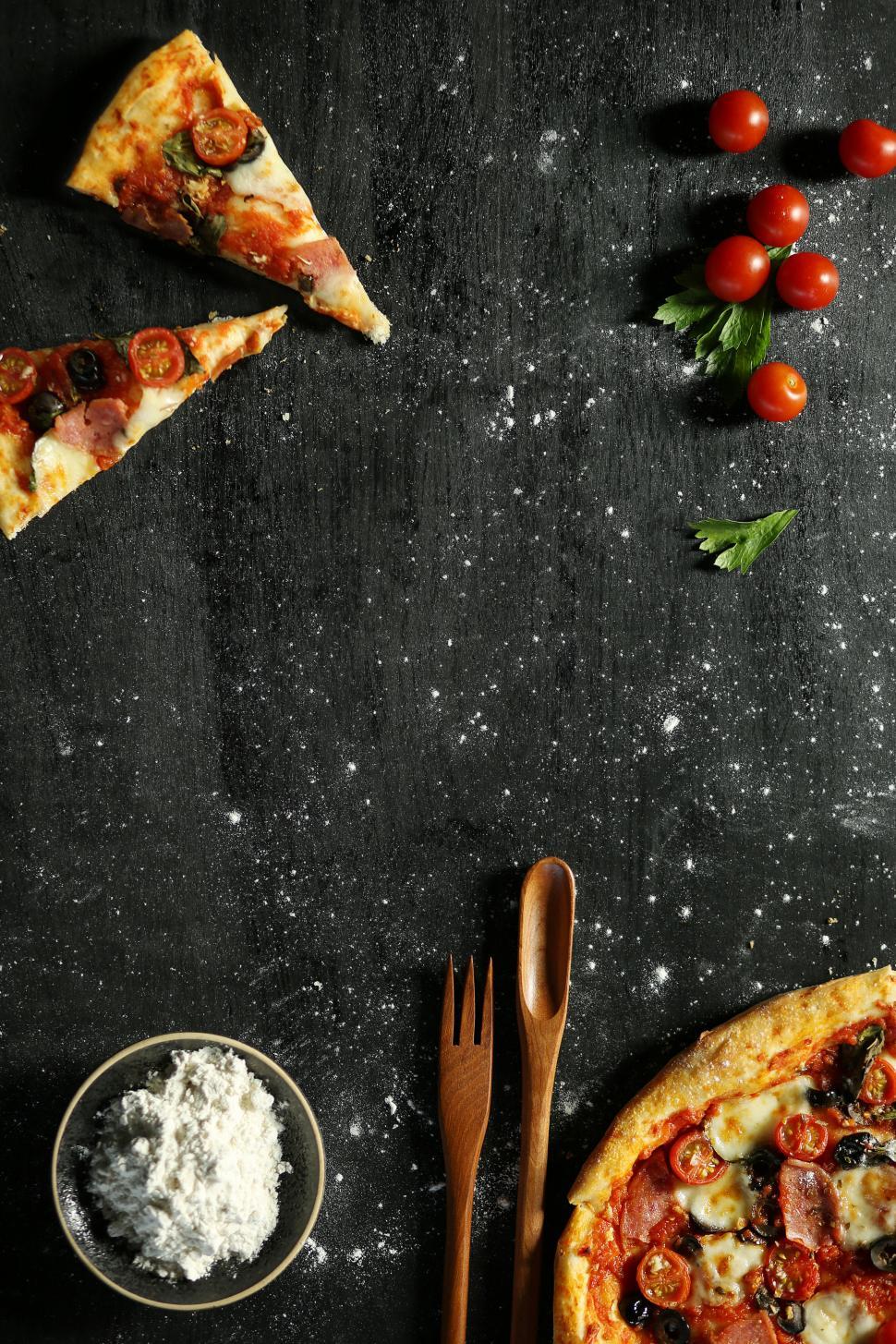 Free Image of Pizza slices and pizza on table on dark wooden table 
