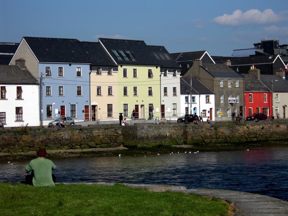 Free Image of Person Sitting on Bench by Waterfront 