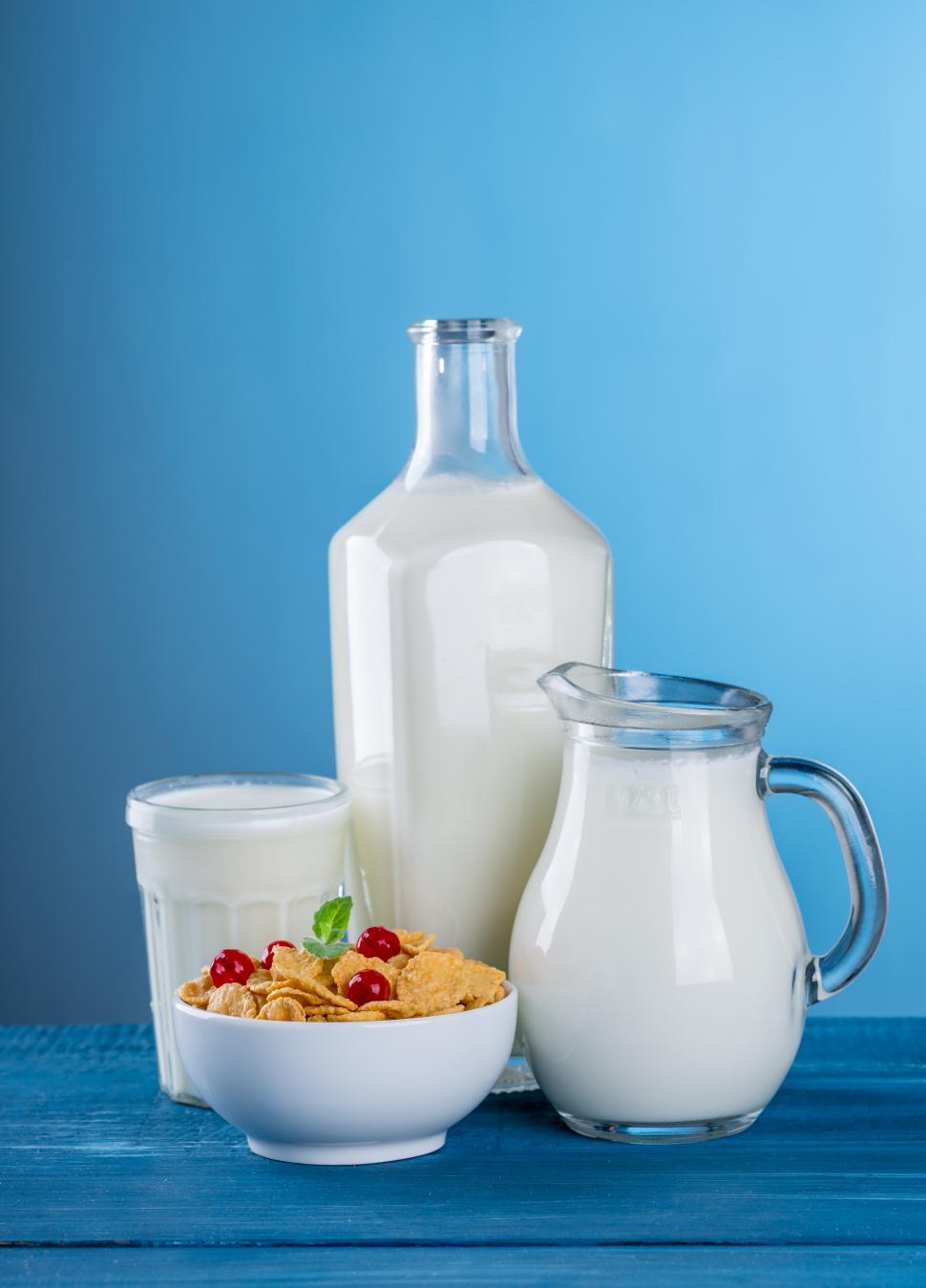Free Image of Close up of a glass, a pitcher and a bottle containing milk 
