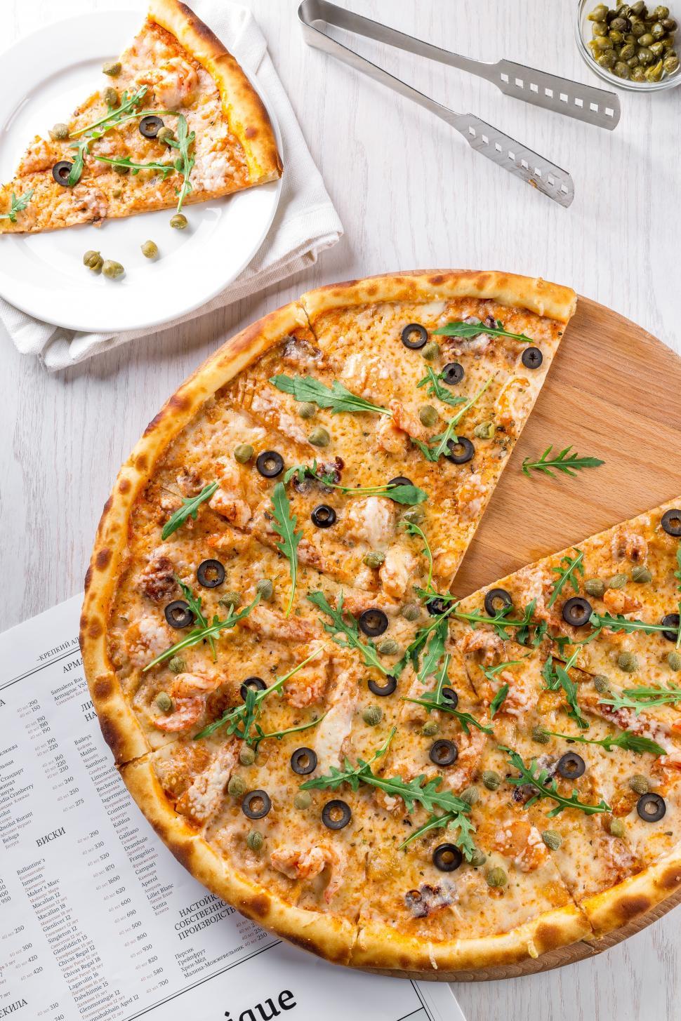 Free Image of Sliced pizza on table 