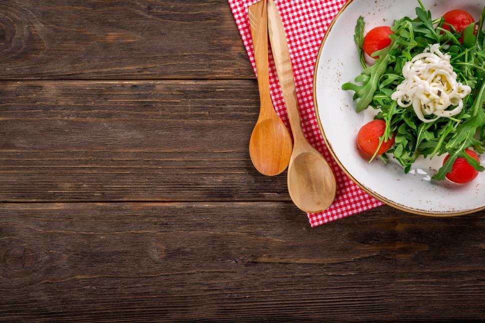 Free Image of Overhead view of vegetable salad on dark wooden background 