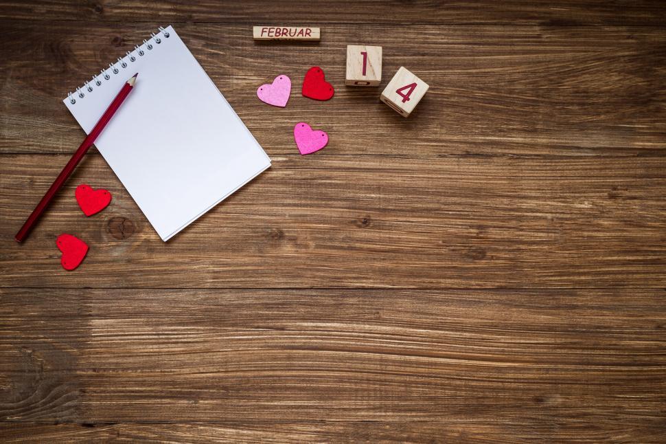 Free Image of Overhead view of a spiral note pad and a color pencil 