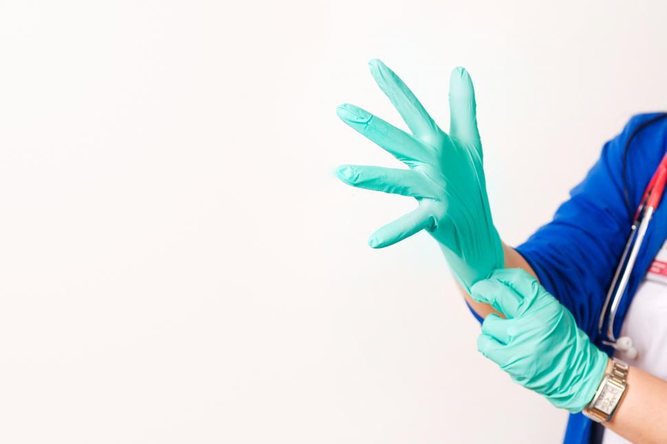 Free Image of Provider pulling on gloves, with white copyspace 