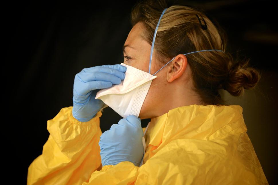 Free Image of Woman in Mask, Gloves, and Gown - PPE 