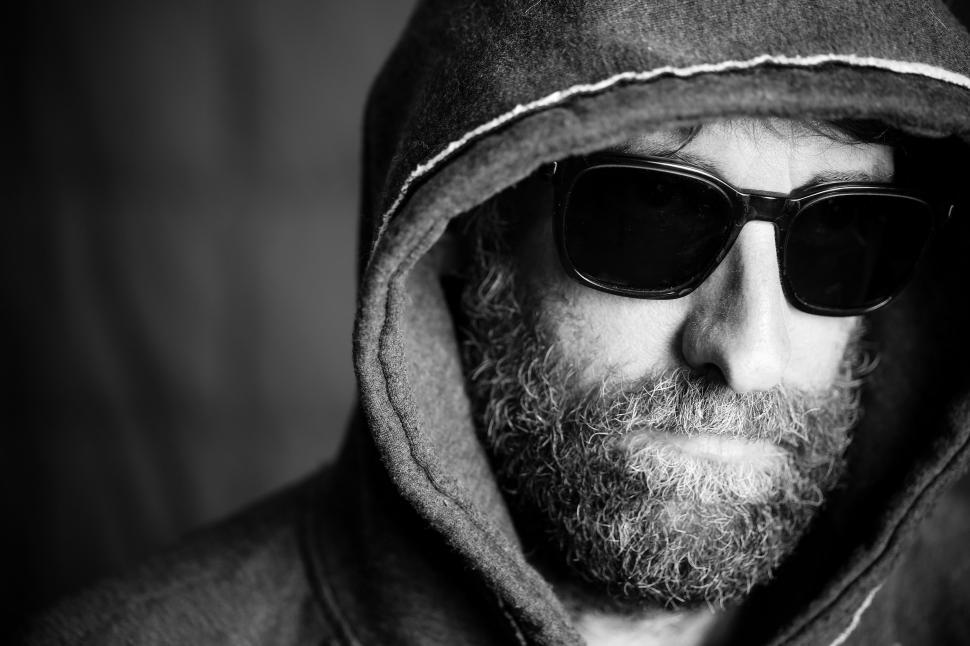 Free Image of Menacing Person in Hoodie and Sunglasses  