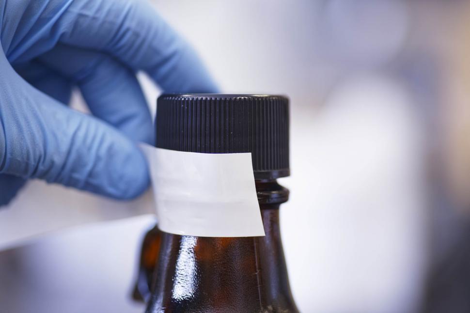 Free Image of Taping chemical bottle 