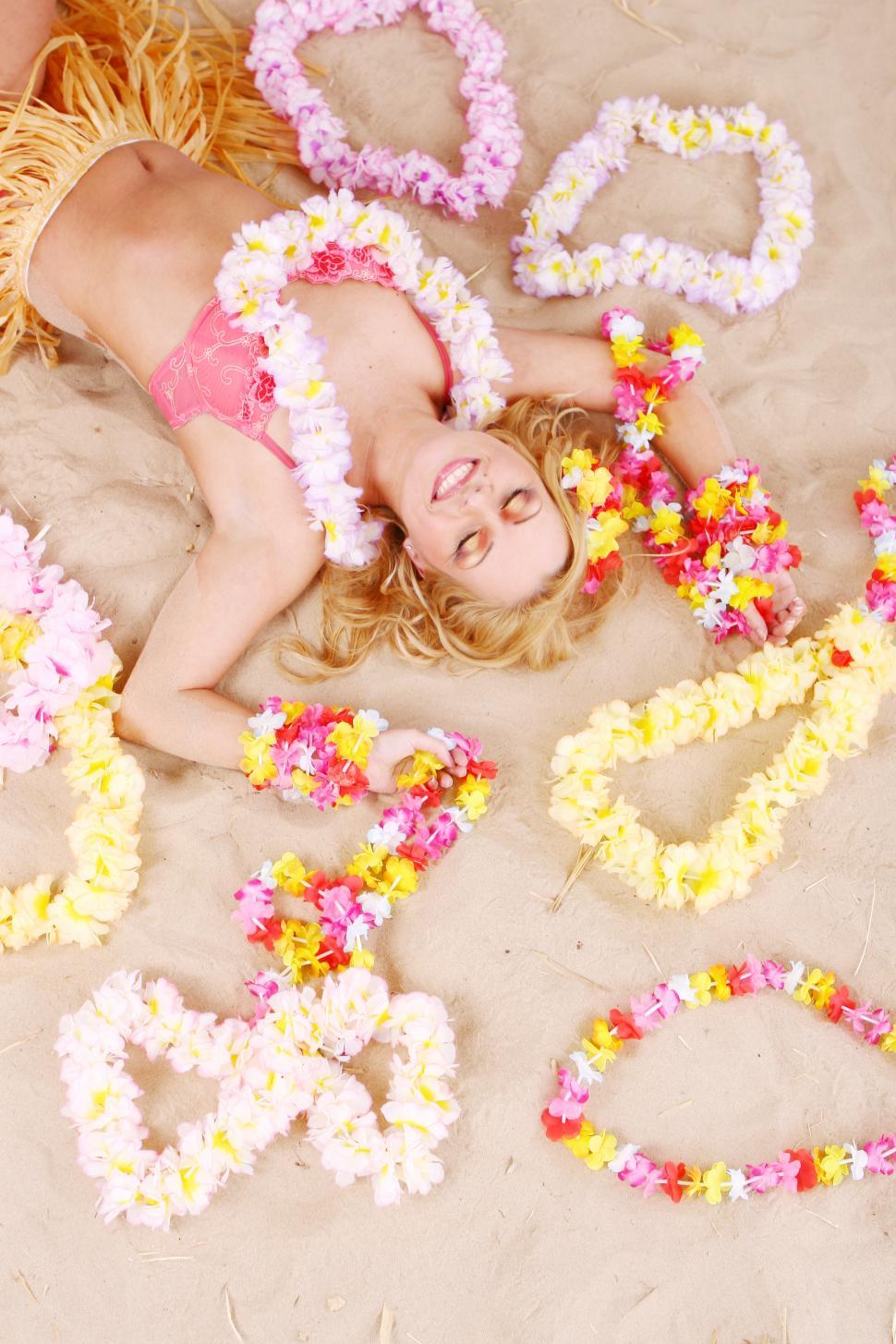 Free Image of Beautiful woman relaxing hawaii style with Lei 