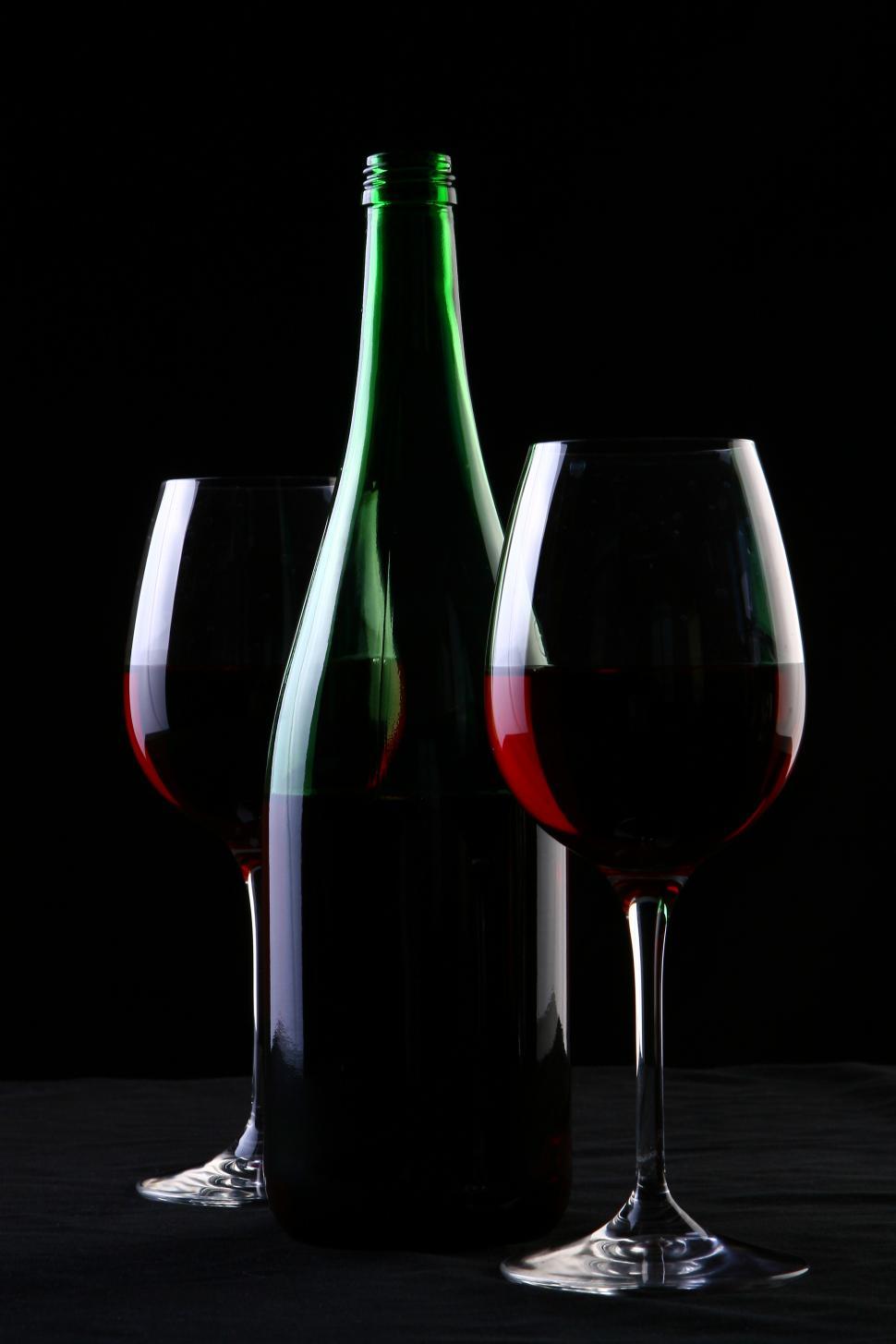 Free Image of a two glasses of red wine on black 