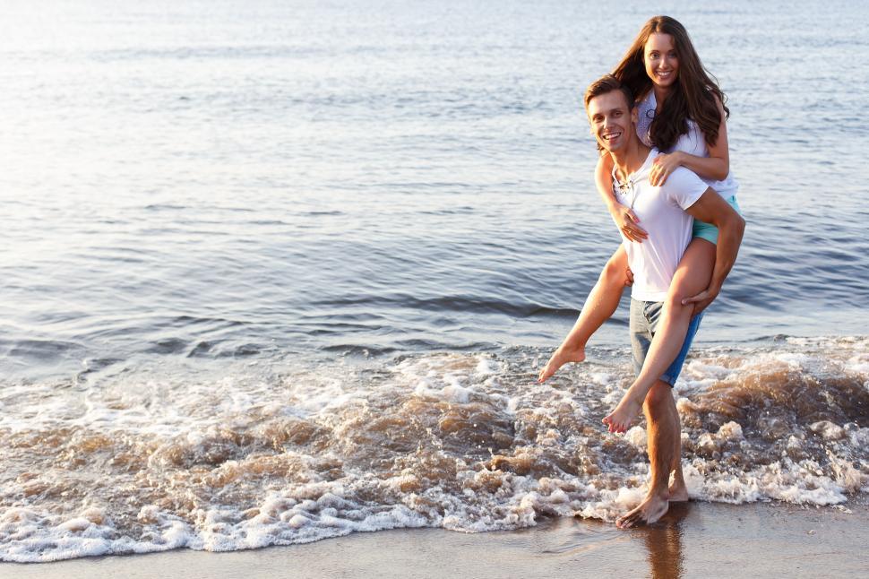 Free Image of Piggyback ride on the beach 