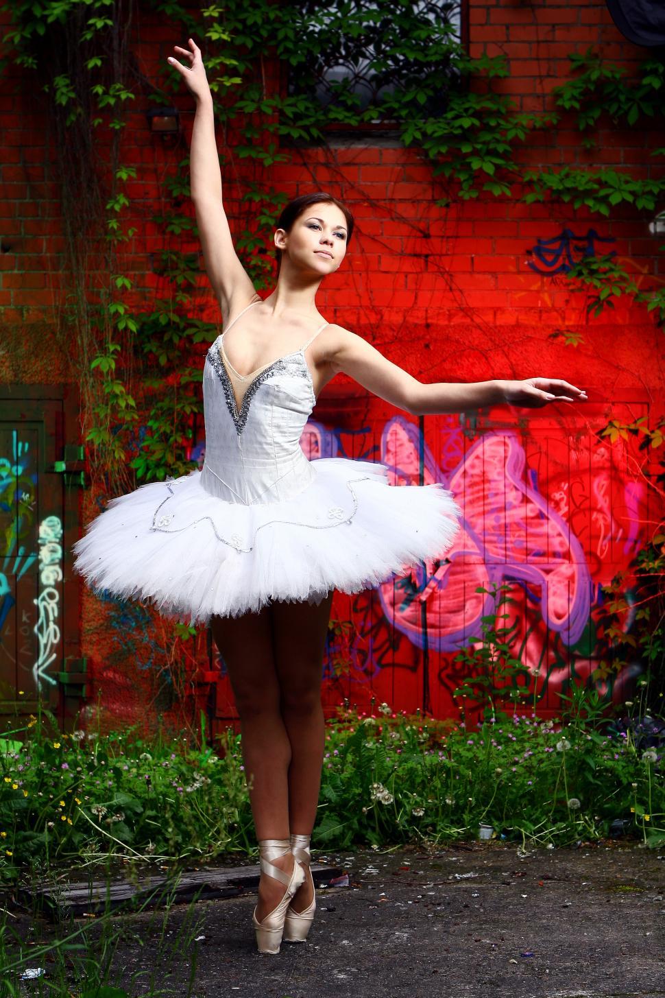Free Image of beautiful ballerina dancing ballet on colorful background 