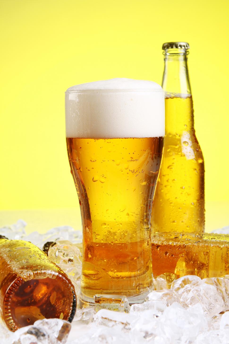 Free Image of Glass of beer with foam on yellow background 