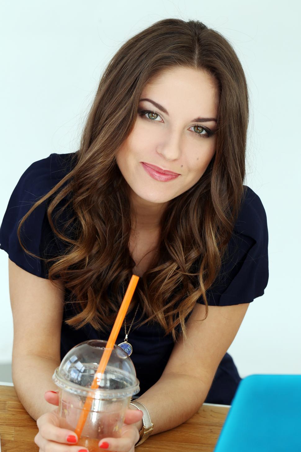 Free Image of Brunette woman looking at camera from work desk 