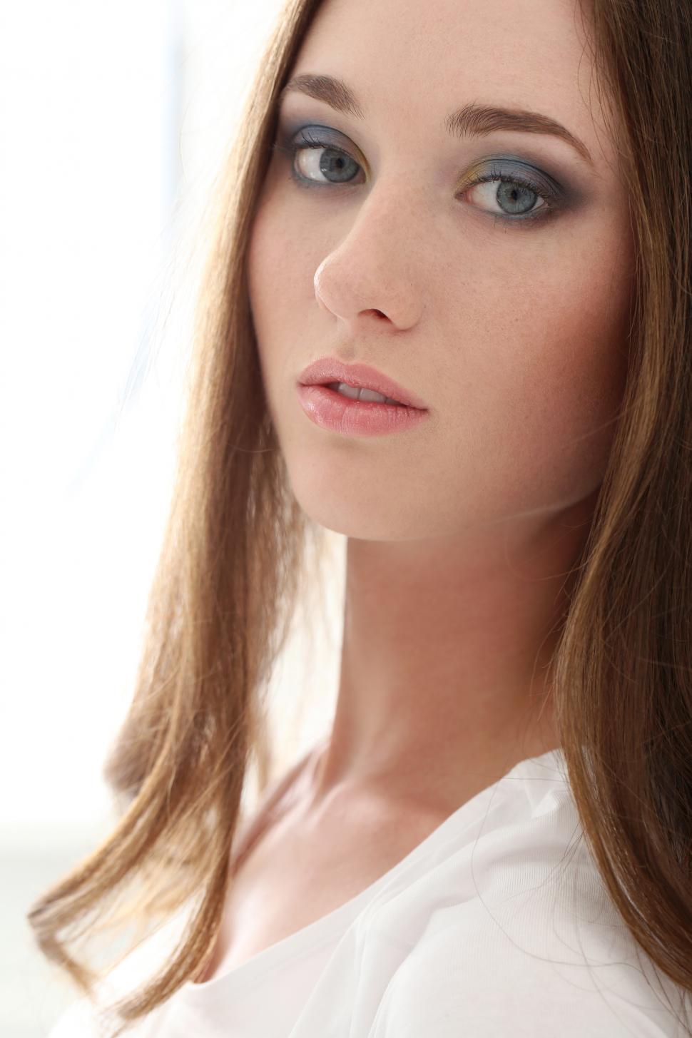 Free Image of Attractive woman looking at camera, white background 