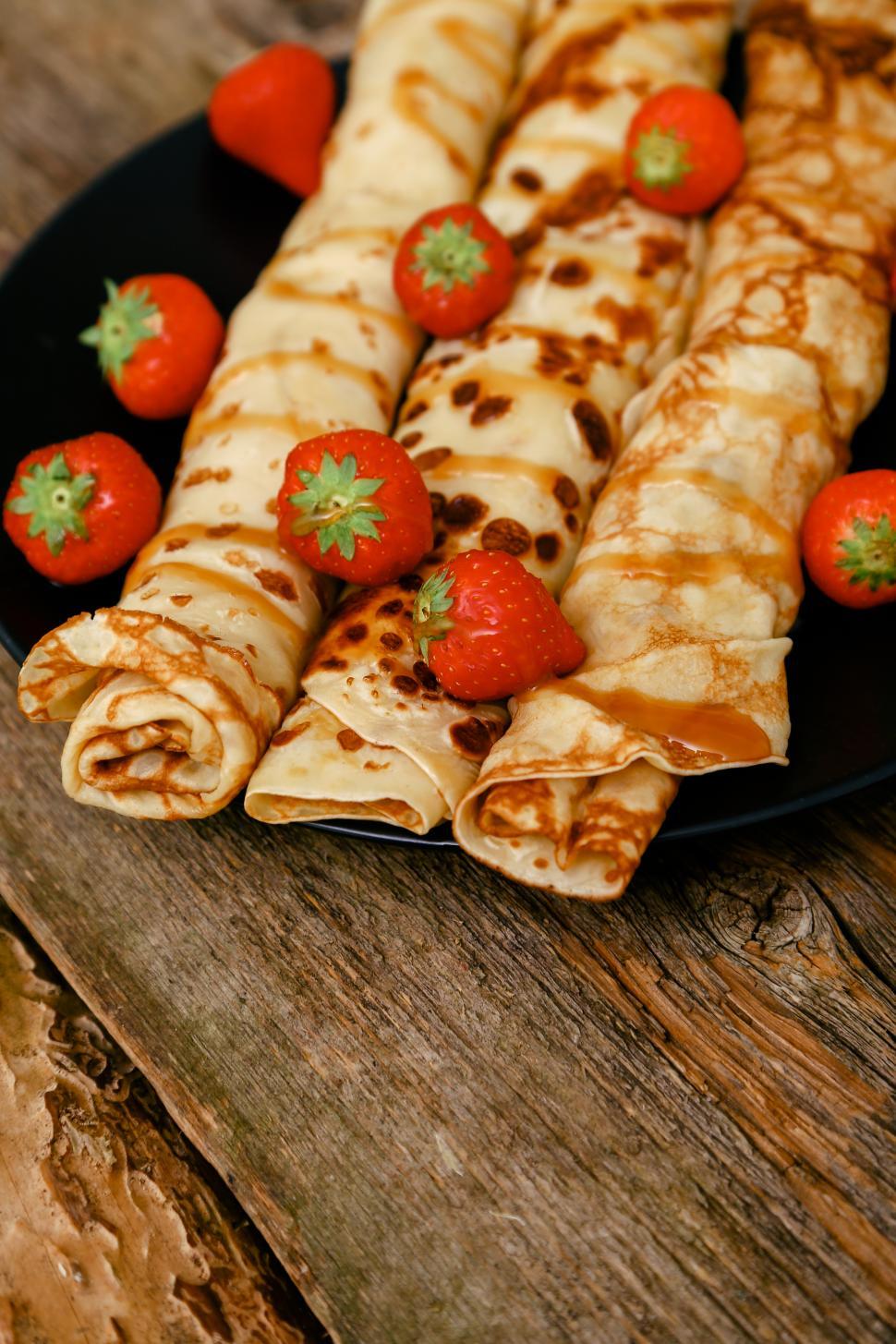Free Image of Homemade pancakes - blinis rolled with fruit 