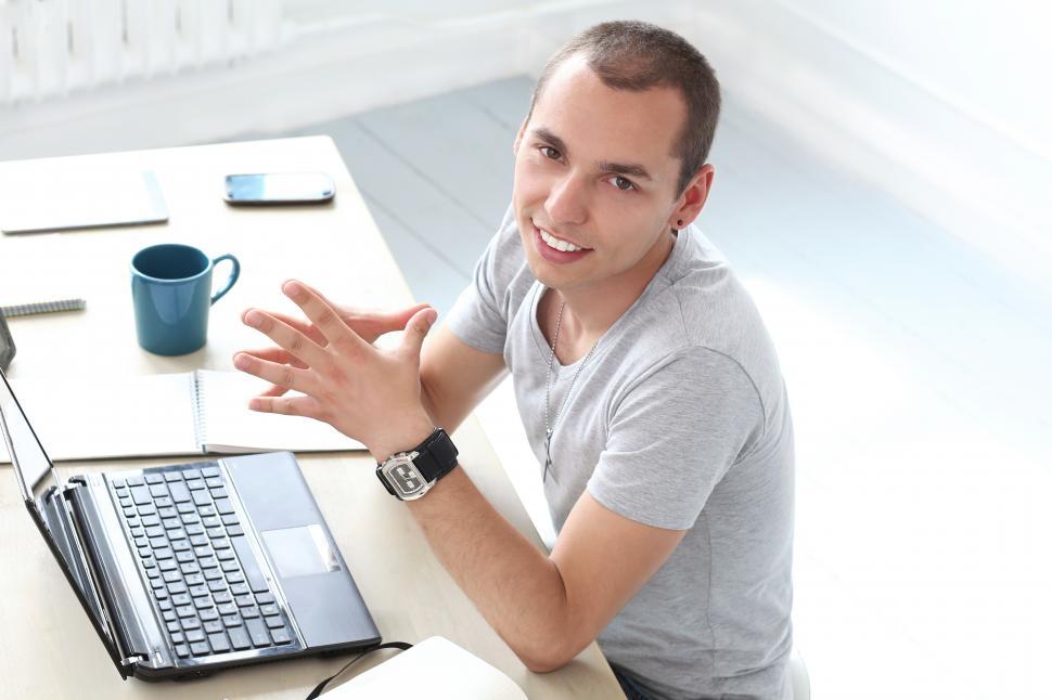 Free Image of Office. Happy man at work sitting at desk 