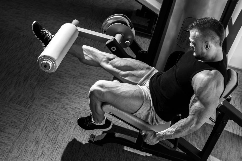 Free Image of Gym. Man doing leg workout. Black and white 