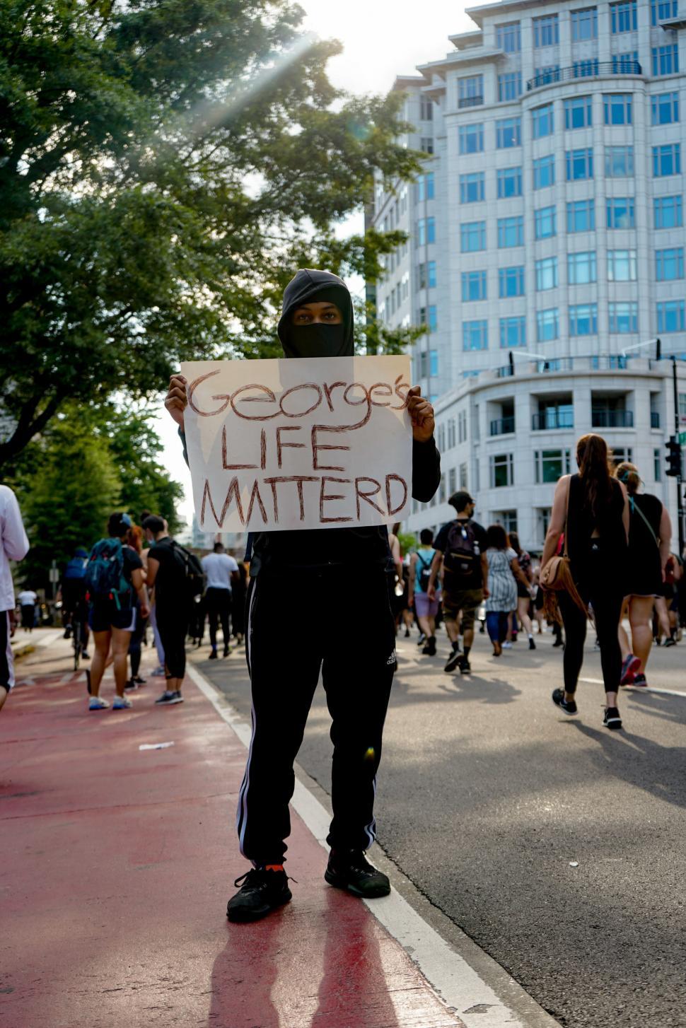 Free Image of Protester with George Floyd sign 